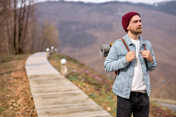 Young caucasian man in nature, looking at side, enjoying the scenery, landscapes - 写真・画像