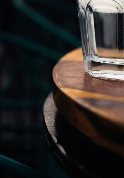 A vertical shot of an empty glass on a wooden table - Photo, Image