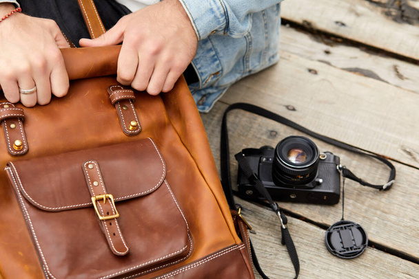Leather Backpack accessories. Close-up photo of male traveler hands opening backpack. - Foto, Imagem
