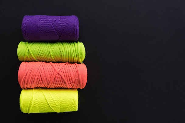 Skeins of cotton yarns for macrame knitting on dark backdrop - 写真・画像