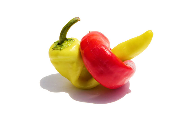 Chili Peppers. Hot Peppers. Red Hot Chili Peppers. Yellow Hot Chili Peppers. Isolated on white. Room for text. Clipping Path. Red and yellow chili peppers. Fresh colorful chili peppers. Chili or sweet peppers.  - Foto, Bild