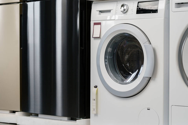 New washing machine in a home appliances store - Fotografie, Obrázek