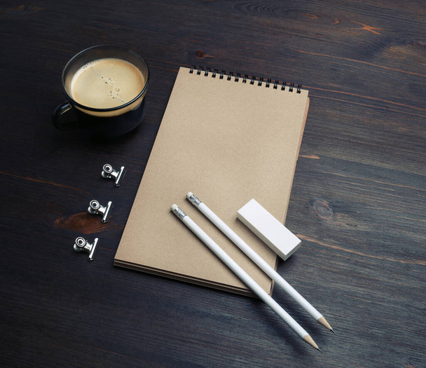 Blank stationery set. Blank notepad, coffee cup, pencil and eraser on wooden background. - Valokuva, kuva