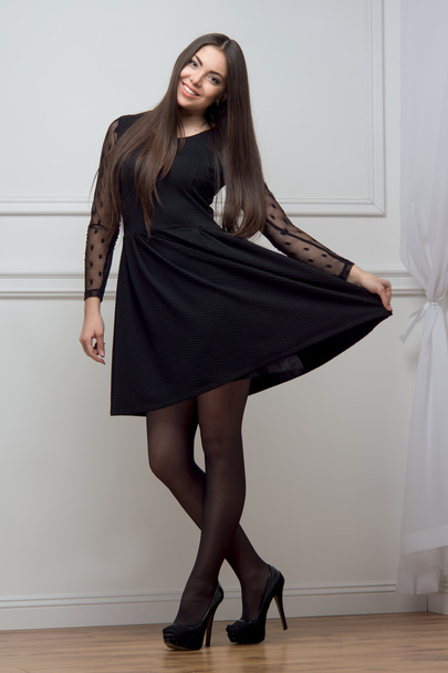 Woman in black dress full length - 写真・画像