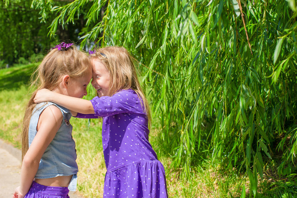 Happy adorable little girls enjoy summer day in the park - Photo, Image
