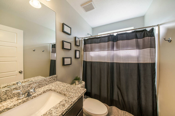 Інтер'єр ванної кімнати з декоративними рамами і суєтою
 - Фото, зображення