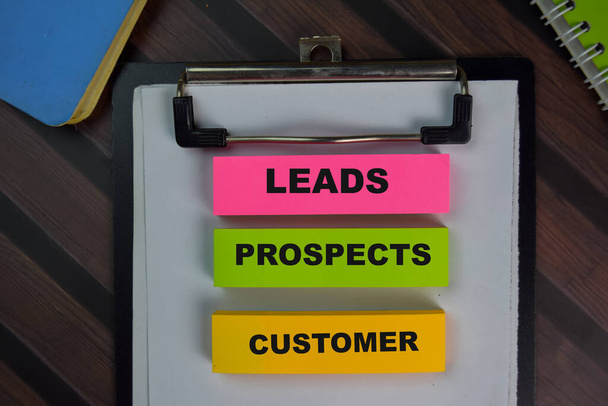Leads Prospects Customer write on sticky notes isolated on Wooden Table. - Photo, Image