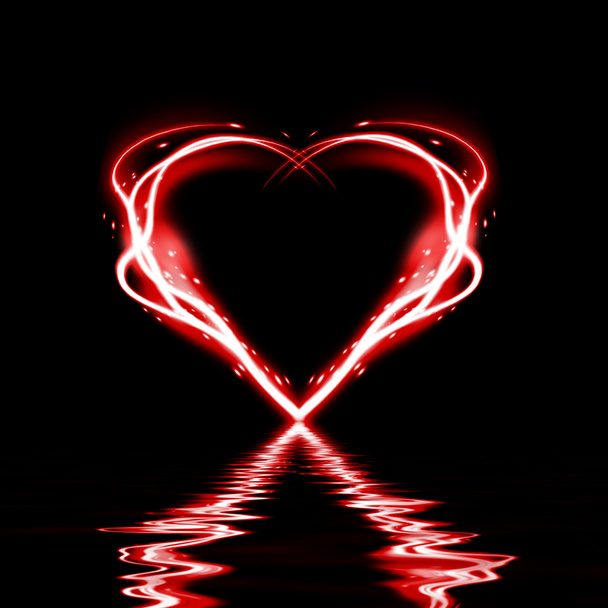 Glowing heart on a black background - Photo, Image