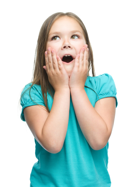 Cute girl is holding her face in astonishment - Foto, immagini