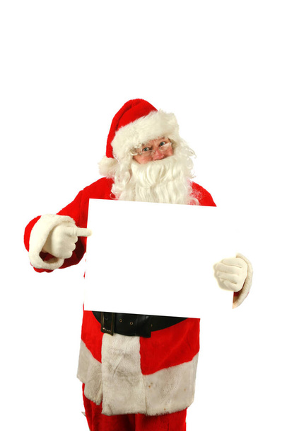 Christmas. Santa Claus. Santa Claus holds a Blank White Sign. Isolated on white. Room for text. Clipping Path. Santa Claus holds a Blank White Sign. Santa Isolated on white with a Blank Sign. Room for your text or image. Merry Christmas. Merry Xmas.  - Photo, Image
