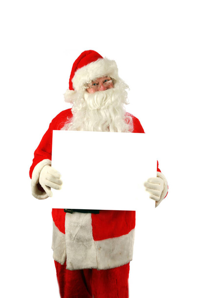 Christmas. Santa Claus. Santa Claus holds a Blank White Sign. Isolated on white. Room for text. Clipping Path. Santa Claus holds a Blank White Sign. Santa Isolated on white with a Blank Sign. Room for your text or image. Merry Christmas. Merry Xmas.  - Photo, Image