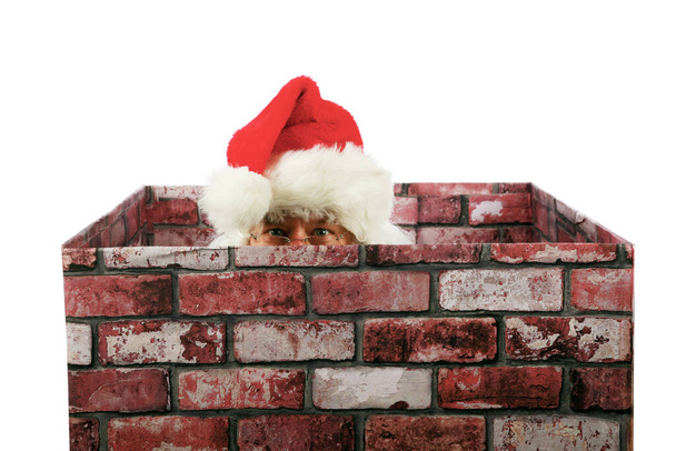 Christmas. Santa Claus. Santa Claus in a house Chimney. Santa Claus pops in and out of a Chimney. Isolated on white. Room for text. Clipping Path. Santa Claus. Santa sits in a Chimney and has a conversation about Christmas. Merry Christmas. Ho Ho Ho. - Photo, image