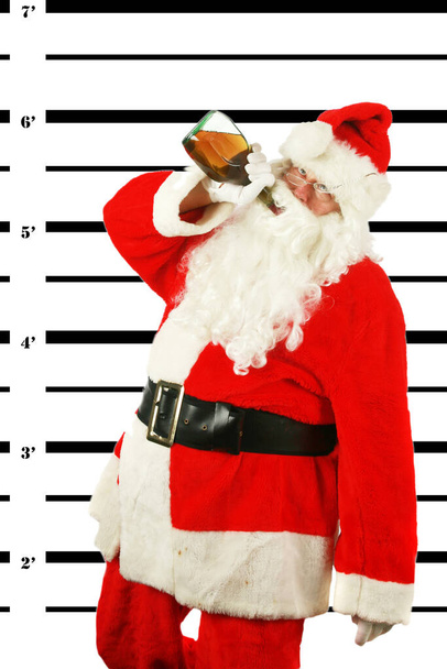 Christmas. Santa Claus. Drunken Santa Claus. passed out drunken Santa Claus. Santa Booking Photo. Bad Santa. Santa Claus has been a Bad Bad Boy. Some lady left him a bottle of Brandy and he drank the whole bottle at once. Santa Claus is Under Arrest. - Photo, Image