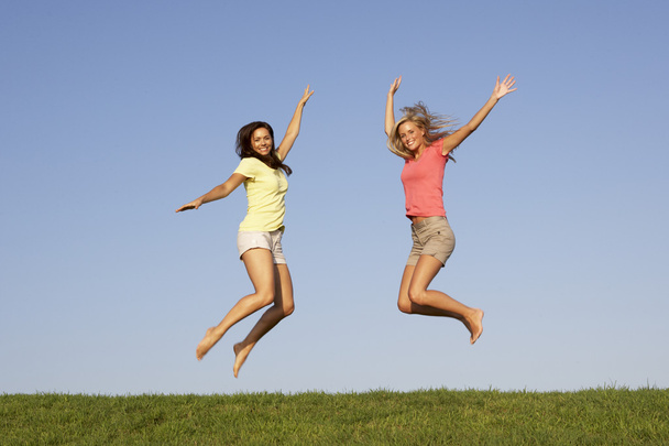 Young women jumping in air - Valokuva, kuva