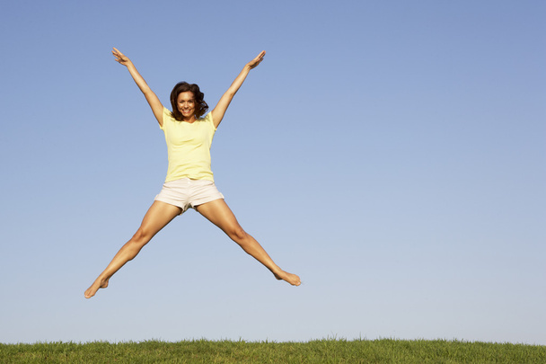 Young woman jumping in air - Photo, image