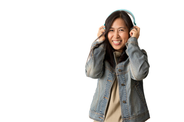 Happy Asian woman wearing wireless headphones listening to music, isolate on white background. - Фото, зображення