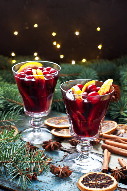 Christmas hot drink with citrus and  cranberry  in glass.  Christmas and winter warming beverage - Foto, imagen