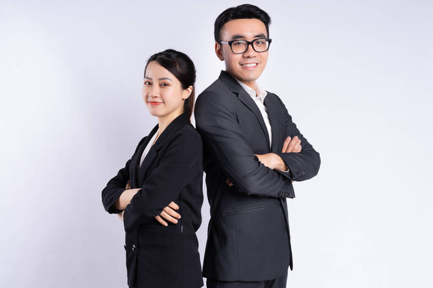Asian businessman and businesswoman posing on white background - Fotografie, Obrázek