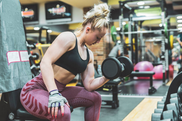 young woman with dumbbells in the gym - Photo, Image
