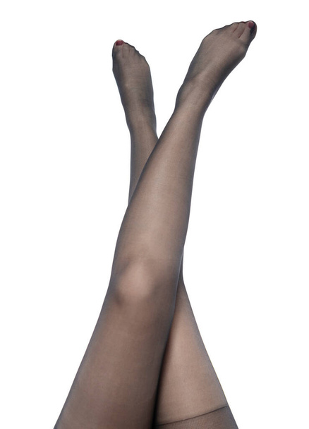 female legs in black tights on white background - Fotoğraf, Görsel