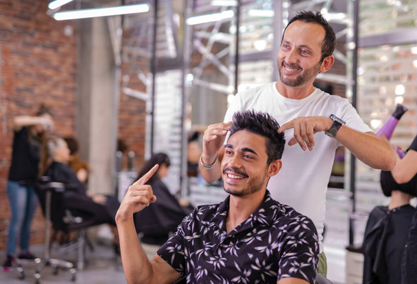 professional hairdresser cutting hair in the barbershop - Photo, Image