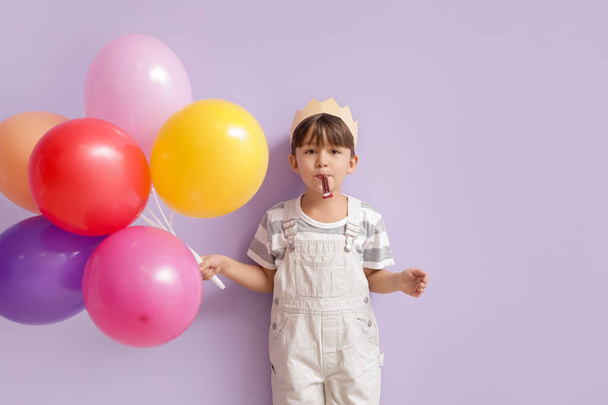 Cute little boy with balloons celebrating Birthday on color background - Foto, immagini