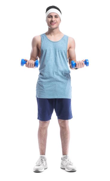 Sporty male coach with dumbbells on white background - Foto, immagini