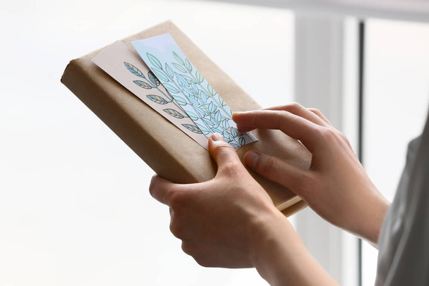 Woman with bookmarks and book at home, closeup - Photo, image
