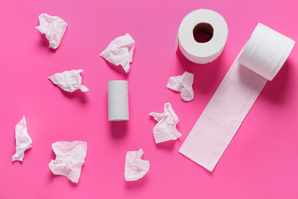 Rolls of toilet paper and crumpled sheets on color background - Photo, Image