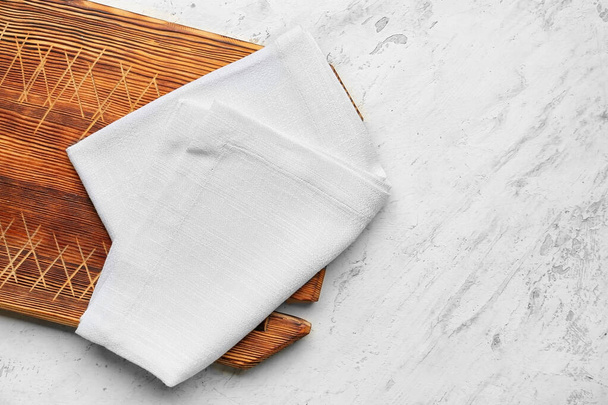 Fabric napkin and wooden board on light background - Photo, Image
