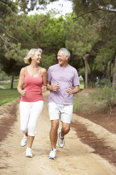 Senior couple running in park - Foto, imagen