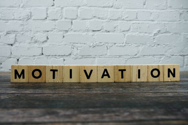 Motivation word alphabet letters on wooden background - Photo, Image