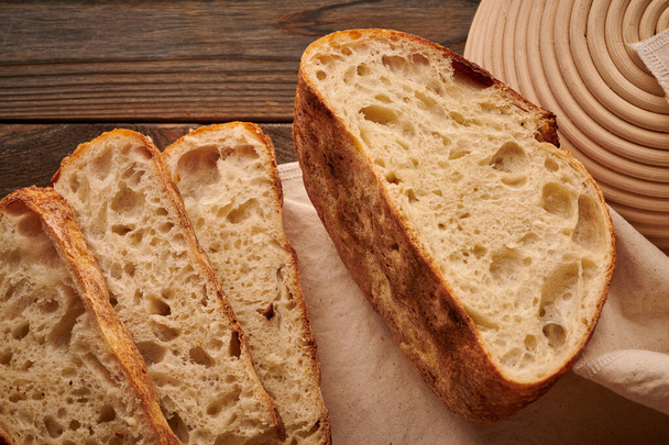 Freshly baked homemade tartine bread on wooden table - Photo, Image