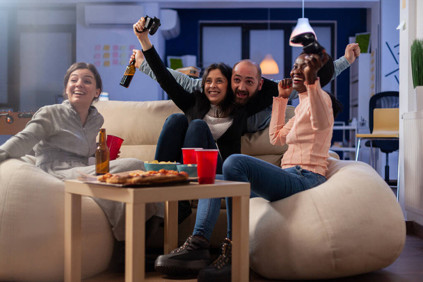 Gli amici multietnici festeggiano insieme dopo lavoro a ufficio - Foto, immagini