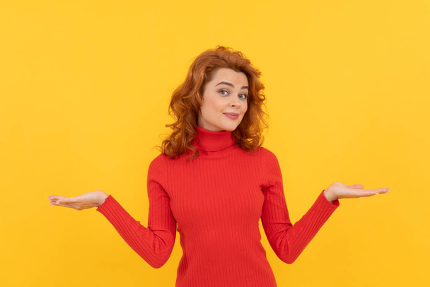 cheerful redhead woman making choice presenting product with copy space for advertisement, choose - Photo, Image