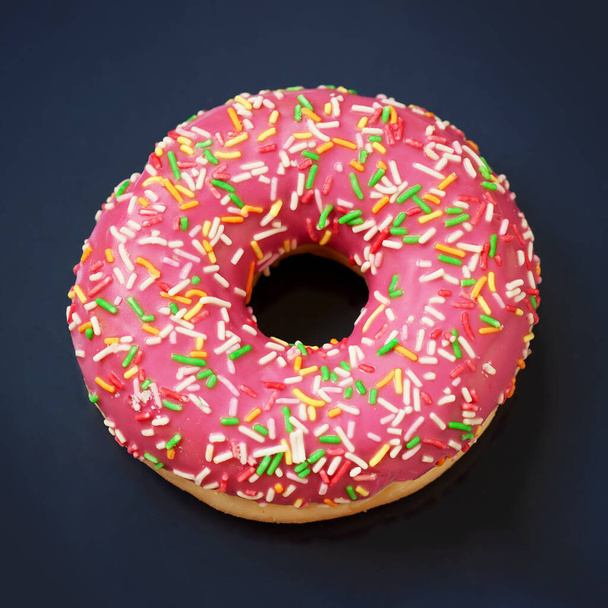 Pink caramel glazed donut on dark background close-up - Foto, Imagem