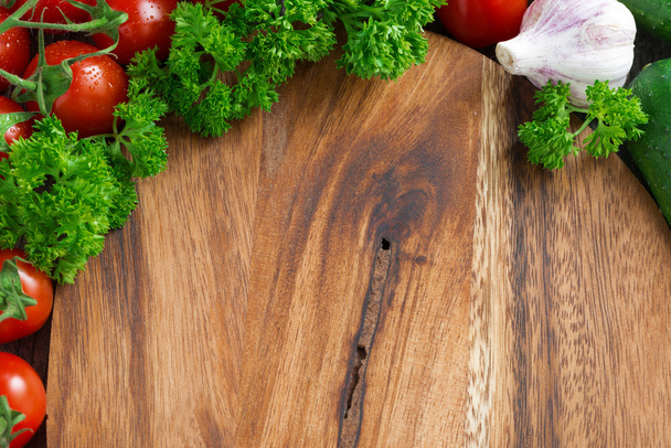 wooden board background, fresh tomatoes and herbs - Фото, изображение