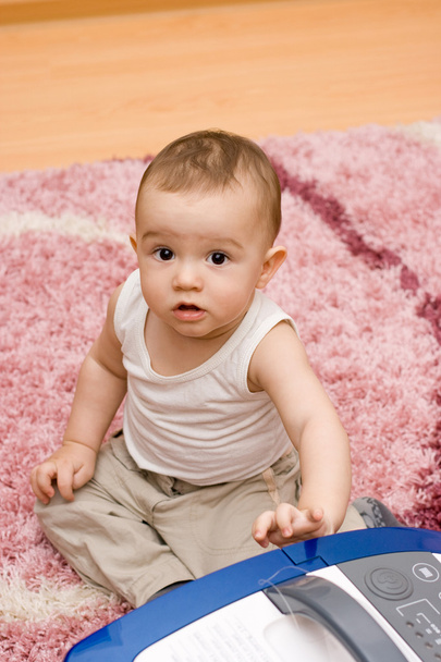 Cute caucasian baby with vacuum cleaner - Foto, imagen