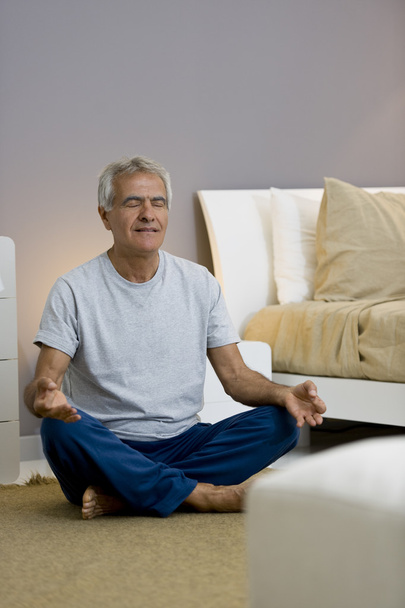 Senior man meditating - 写真・画像