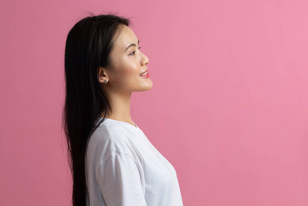 Portrait of asian woman on pink background - Photo, Image