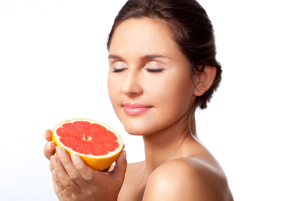 Beautiful woman portrait with half of grapefruit - Foto, immagini
