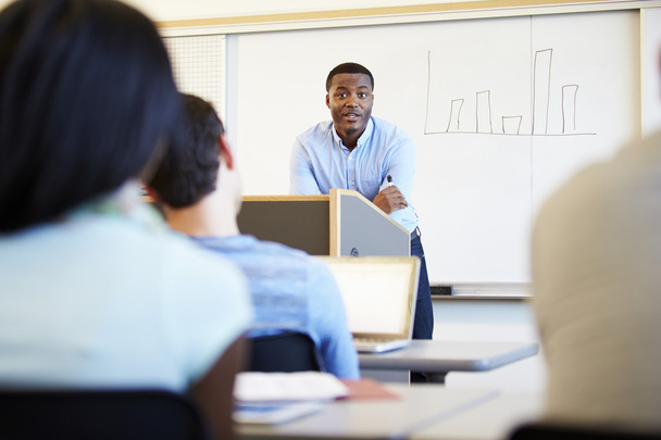 Male Tutor Teaching University Students In Classroom - Fotó, kép