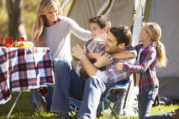 Family Enjoying Camping Holiday In Countryside - Foto, imagen