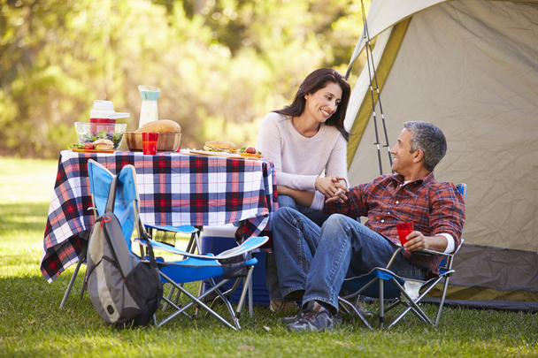 Couple Enjoying Camping Holiday In Countryside - 写真・画像