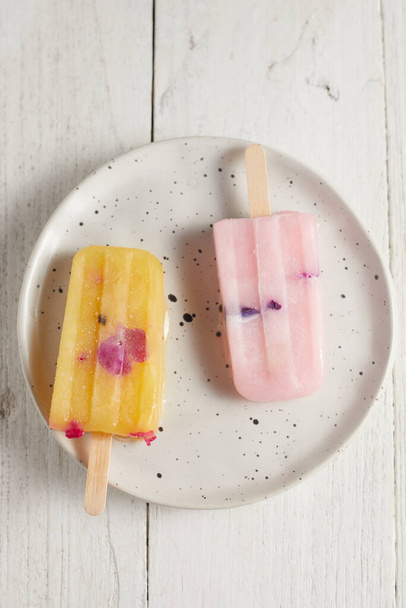 Homemade frozen ice cream popsicles in various flavor - Photo, image