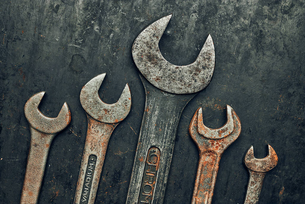 Spanners on steel surface. Old rusty wrenches for maintenance. Mechanic hardware tools to fix. Technical tools background with copy space - Photo, Image