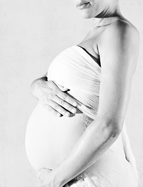 вагітна жінка тримає живіт
 - Фото, зображення