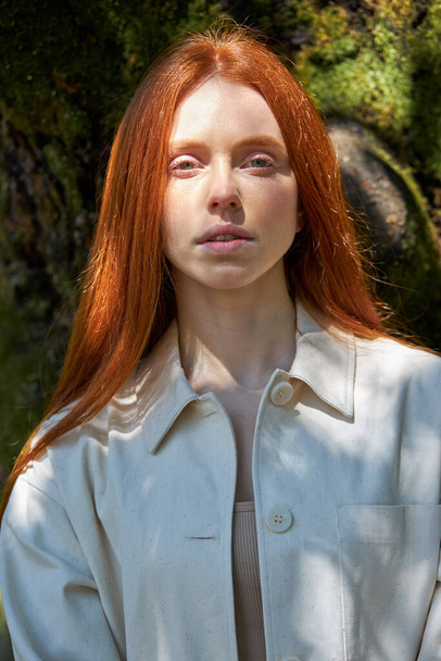 Lifestyle, redhead Caucasian woman in park in nature, among beautiful bamboo trees - Valokuva, kuva