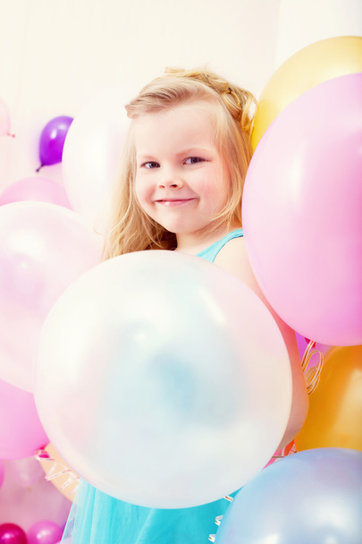 Funny little girl posing with balloons - Photo, image