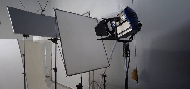 Studio light equipments for photo or film movie video. Light set for professional shooting studio background. LED Flood light and Spot light for video production studio. Setup include Barn door softbox.  - Photo, Image